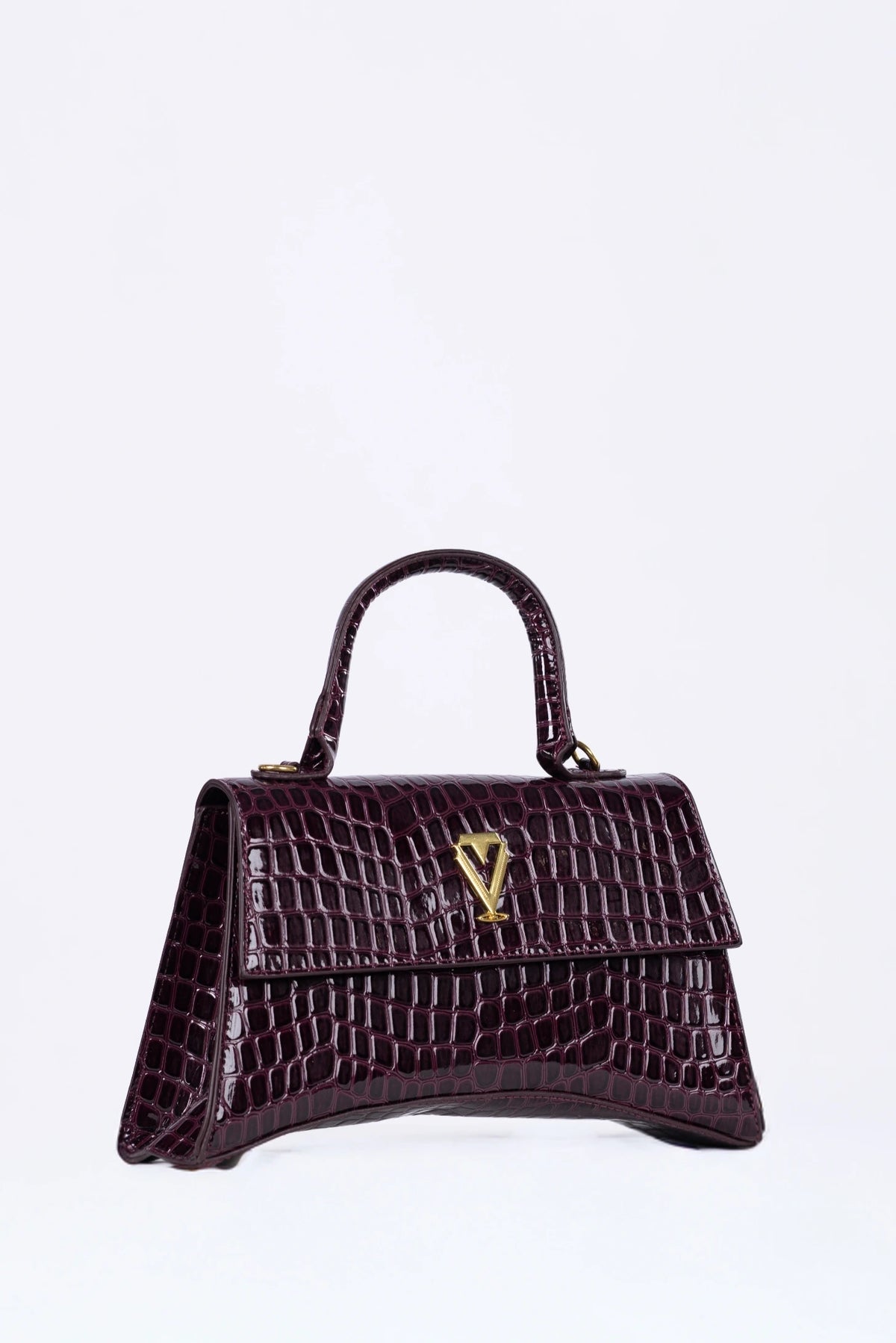 Brown handbag with a gold emblem on a white background