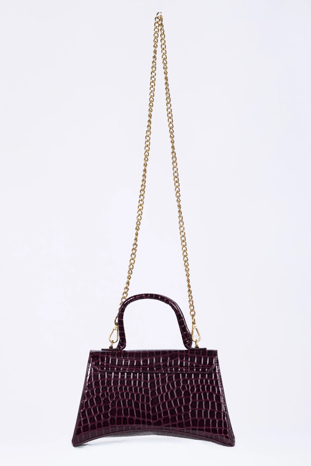 Purple handbag with a gold chain on a white background