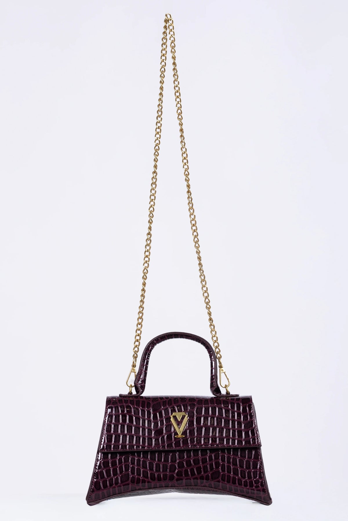 Purple handbag with gold chain on a white background