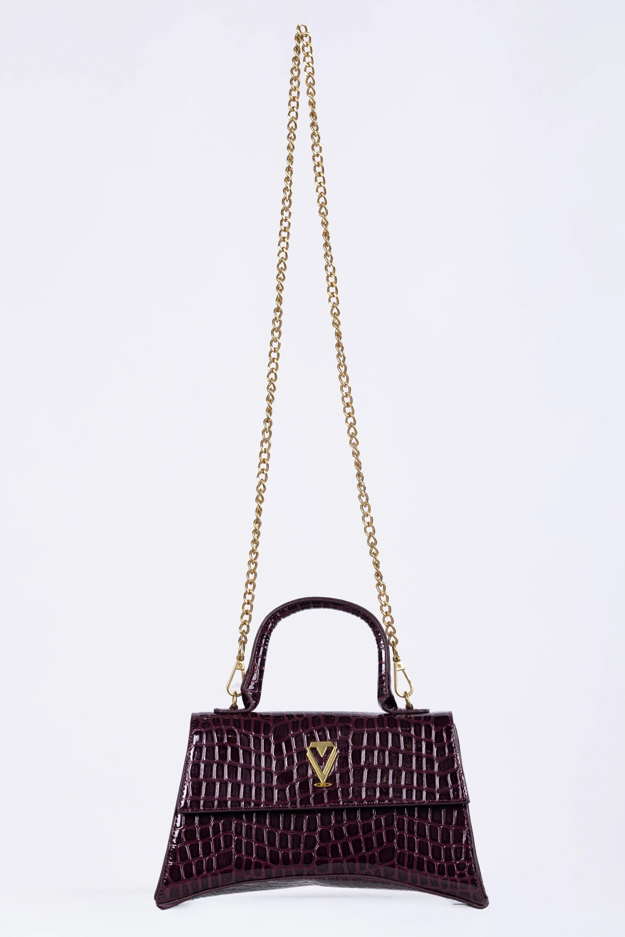 Purple handbag with gold chain on a white background