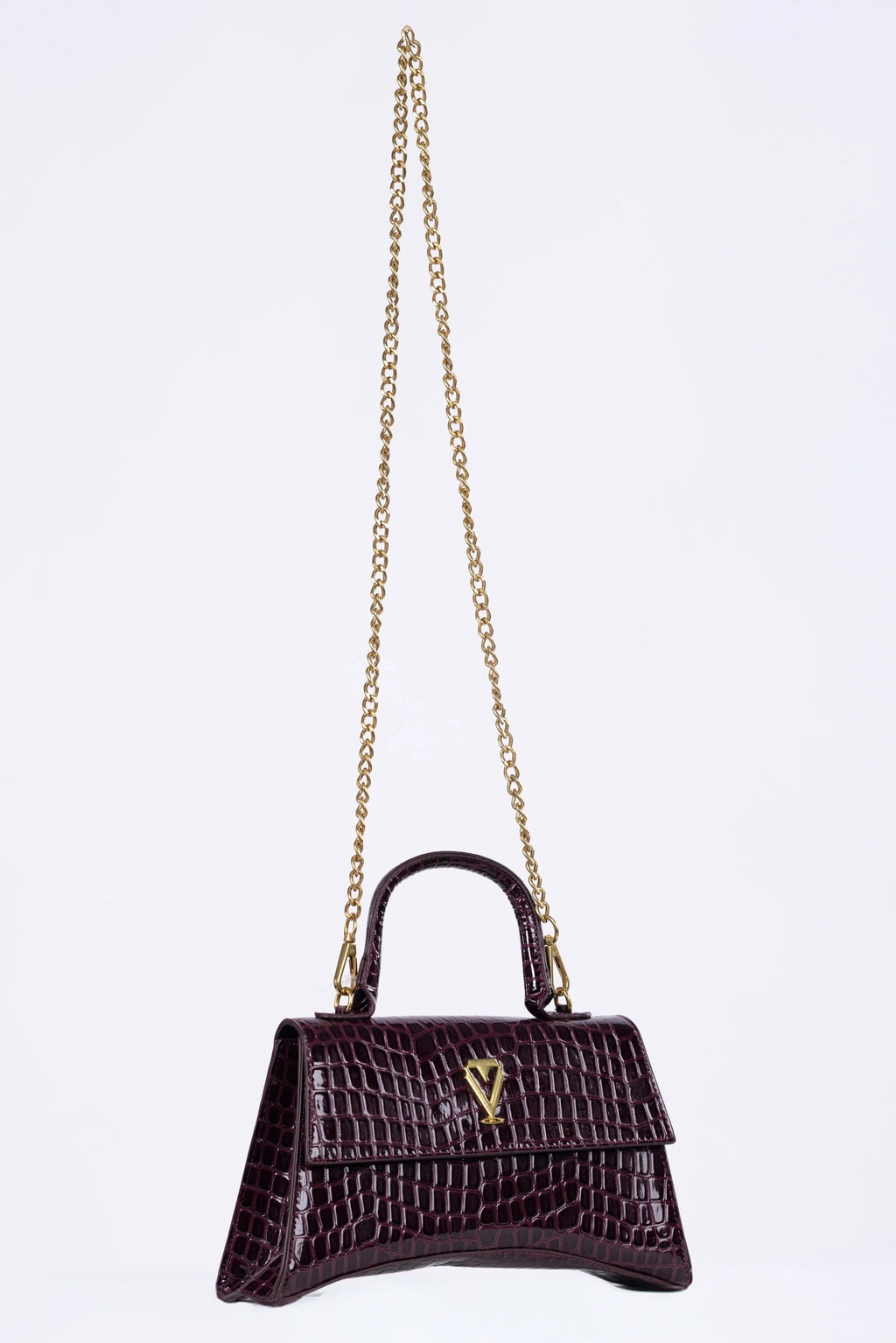 Black handbag with gold chain on a white background