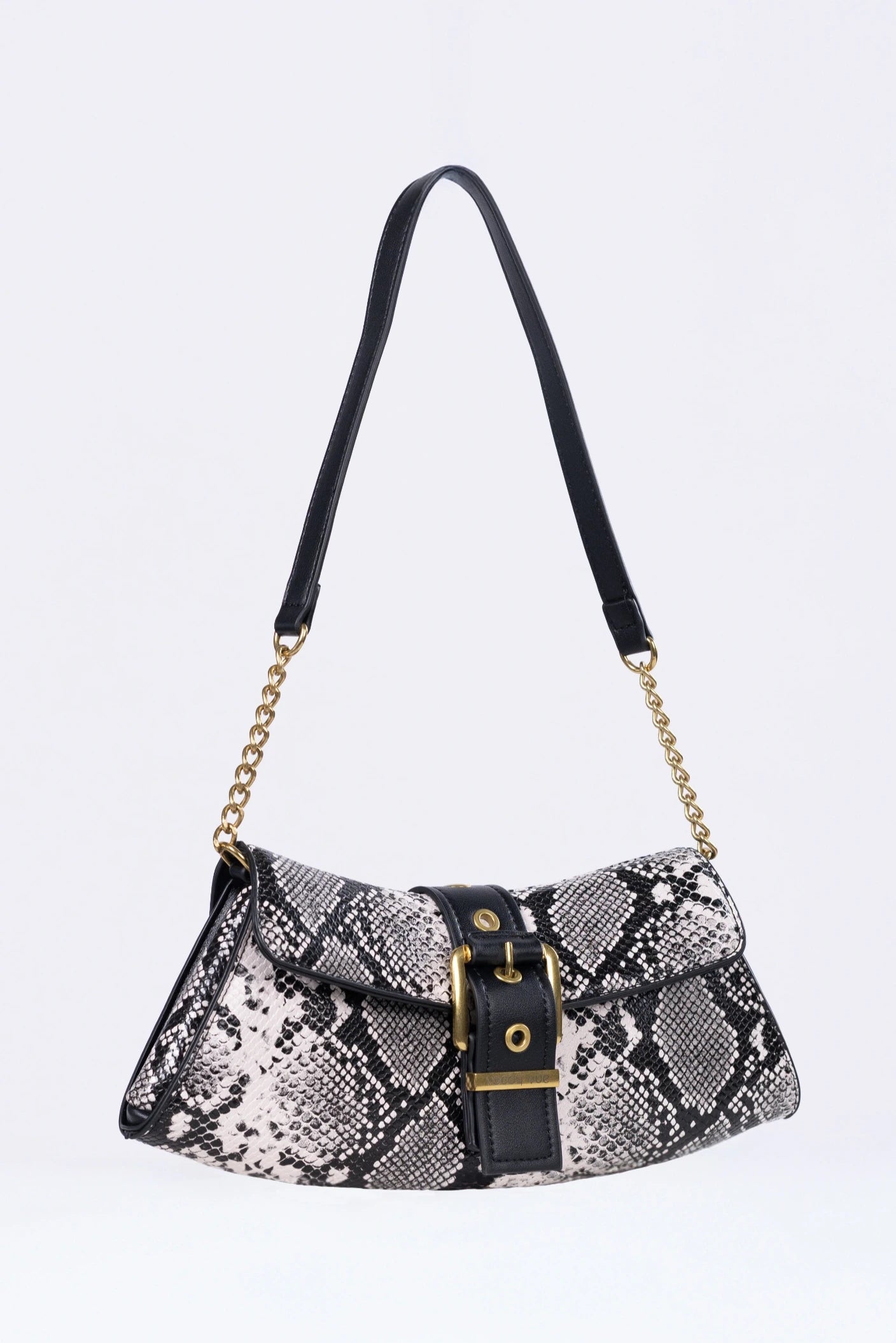 Patterned handbag with a black strap on a white background