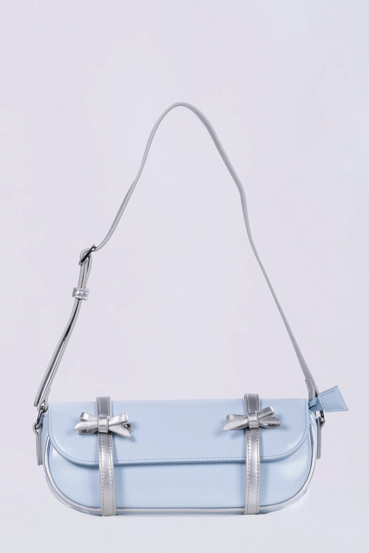 Clear handbag with a strap on a light purple background