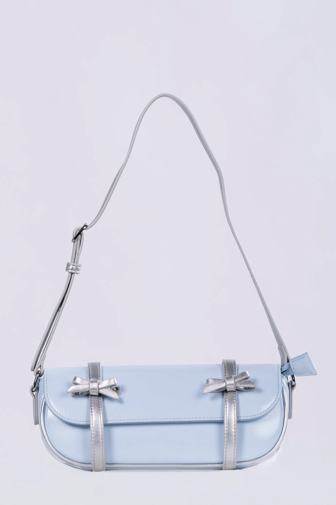 Clear handbag with a strap on a light purple background