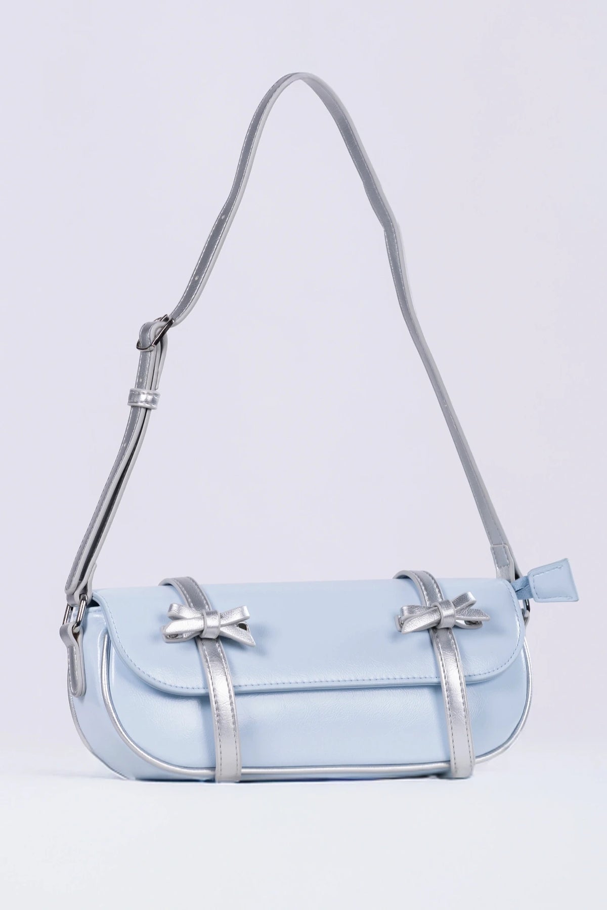 Light blue handbag with a strap on a light gray background
